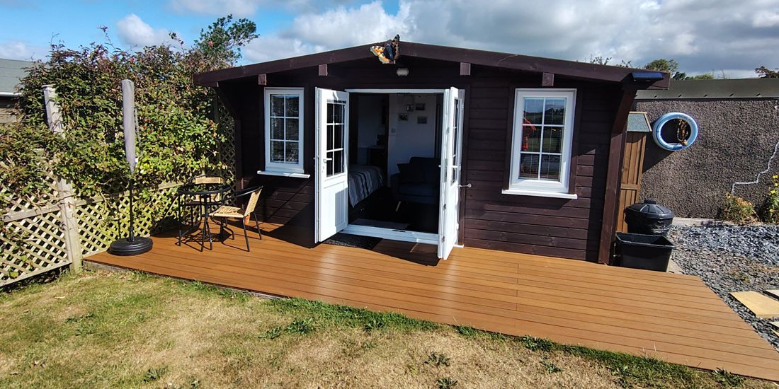 Butterfly Cabin with doors open onto its decked terrace